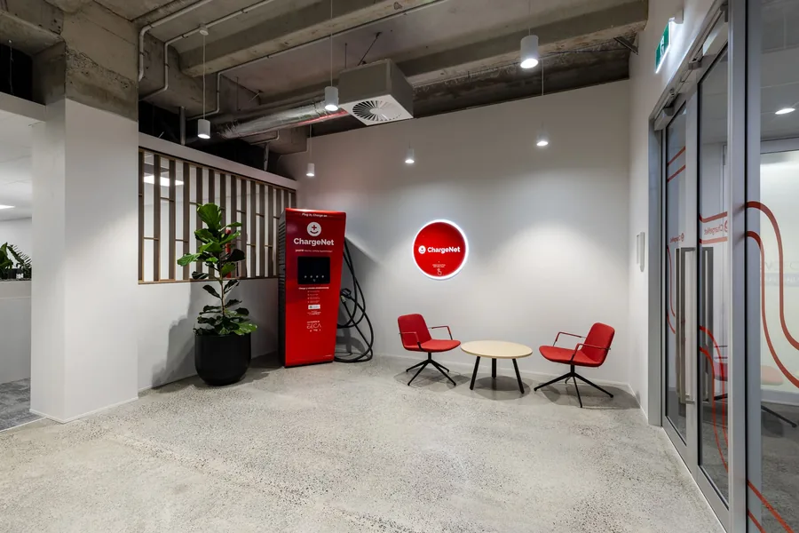 ChargeNet’s Auckland reception, with lounge seating and a charging unit on the back wall